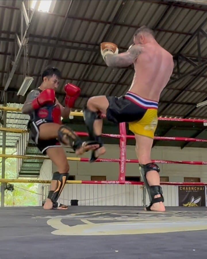 Rob throwing a kick in the Muay Thai ring in Pai