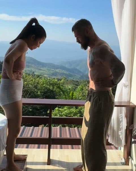 Kai and Rob breathing together on a balcony above the mountains